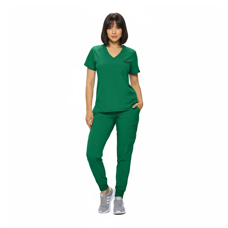 Wholesale women's green v-neck scrub top and jogger pants set with chest pocket and gray sneakers