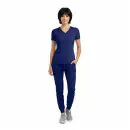 Wholesale women's navy blue v-neck scrub top with short sleeves and matching jogger pants with gray sneakers