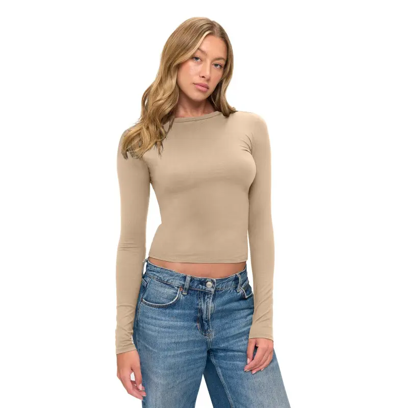 Wholesale women's beige long-sleeve fitted crop top paired with blue denim jeans