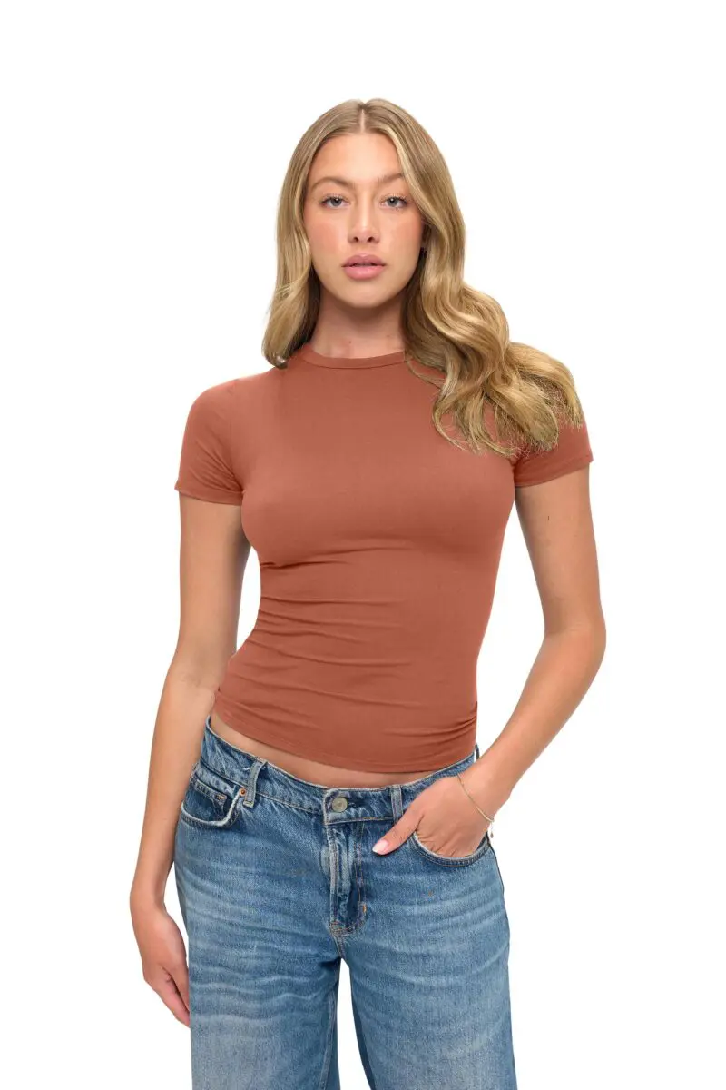 Wholesale women's rust short-sleeve fitted crewneck t-shirt paired with blue denim jeans