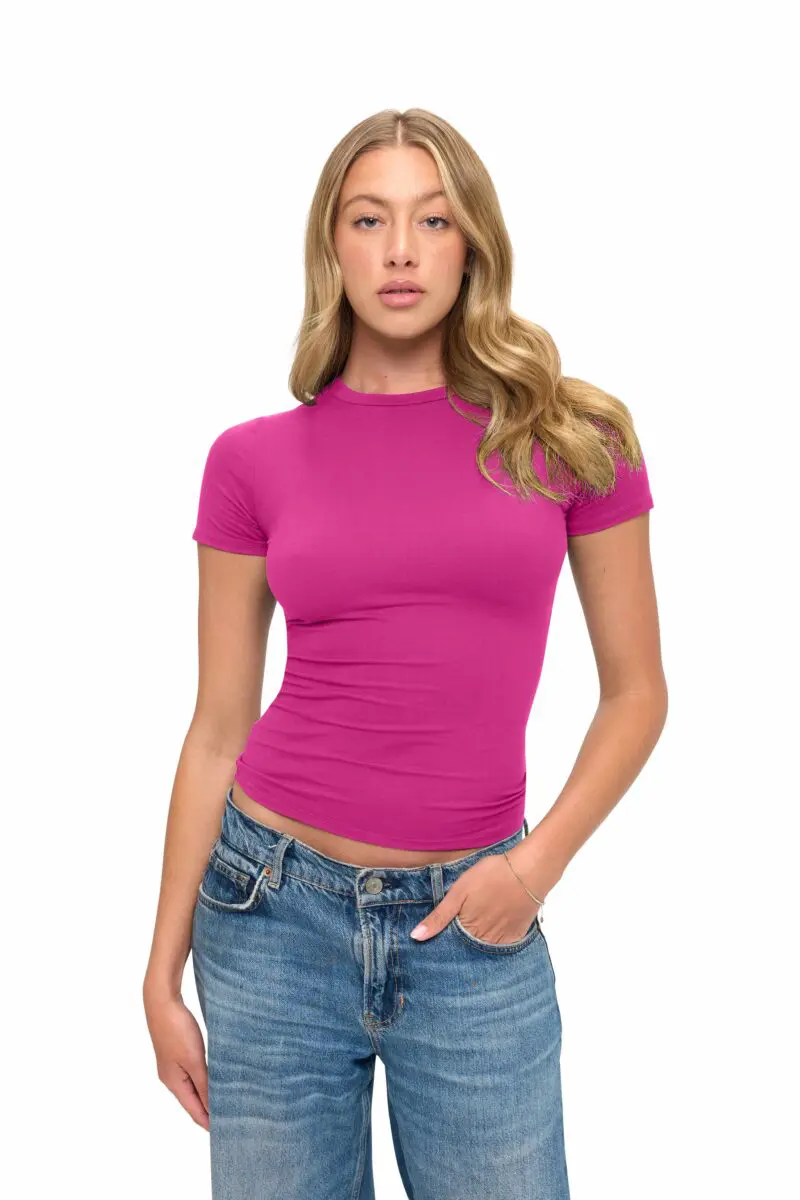 Wholesale women's magenta short-sleeve fitted crew neck t-shirt paired with blue denim jeans