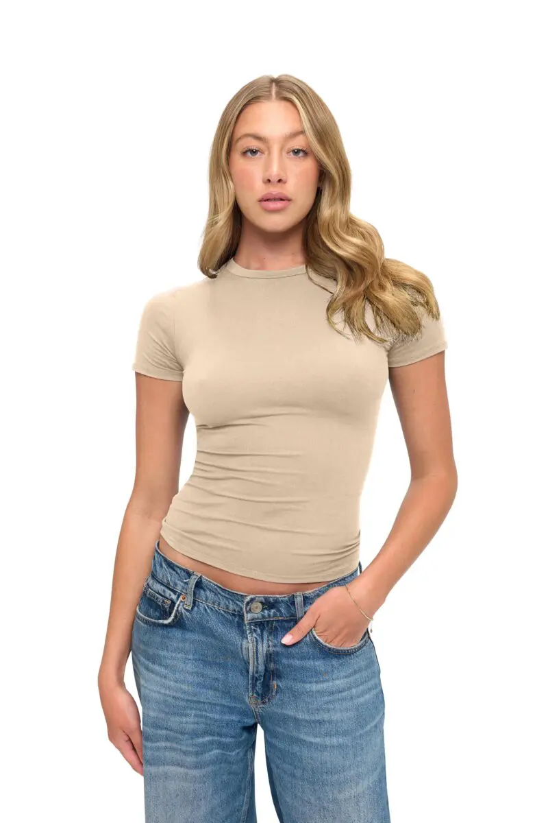 Wholesale women's beige short sleeve fitted crew neck t-shirt paired with blue denim jeans